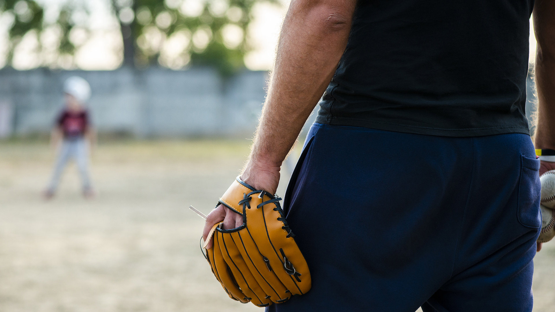 Spring sports injuries prevention with adult recreational athletes warming up before baseball and soccer